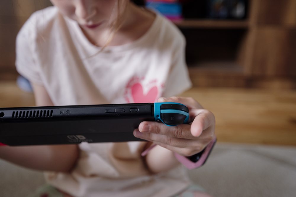 Child playing a video game at home