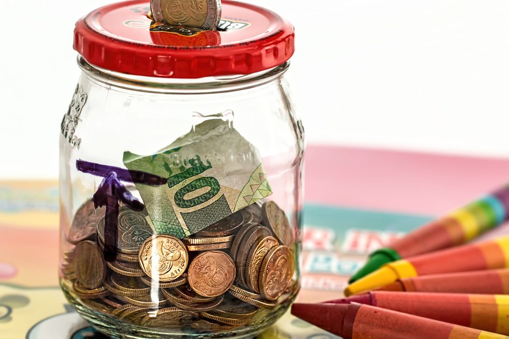 Piggy bank with coins, representing saving money by avoiding recurring app subscriptions