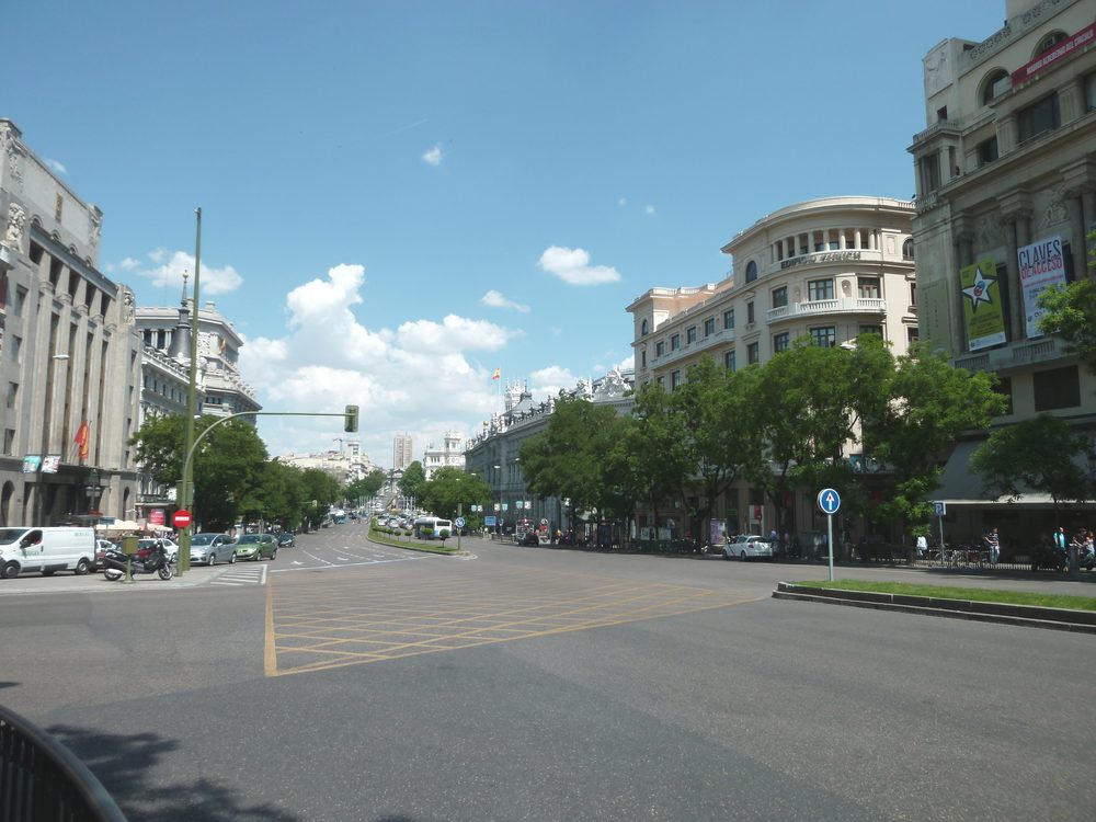 Historic street in central Madrid, Spain, lined with buildings and shopfronts