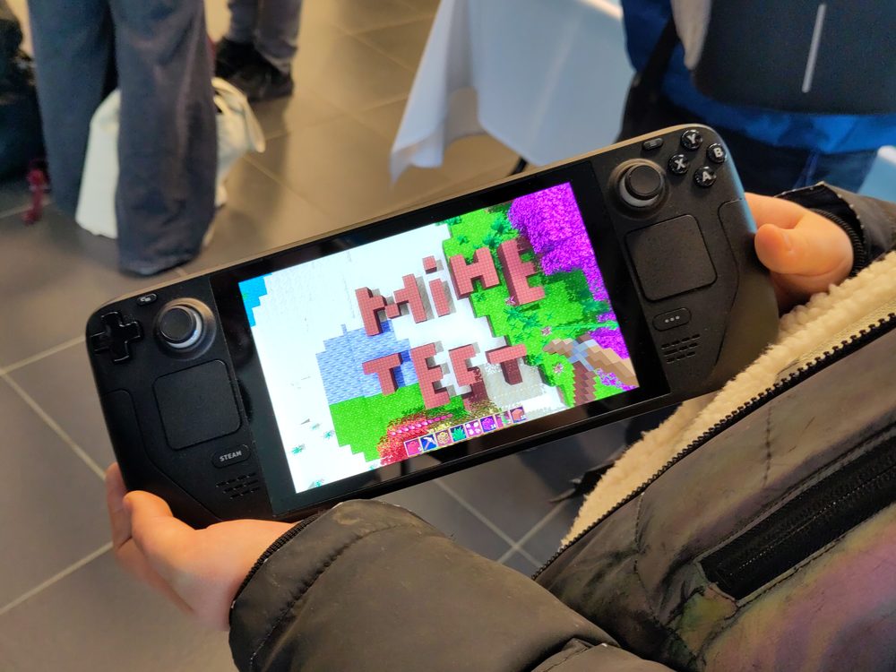 Steam Deck handheld gaming device being used, showing its screen and controls