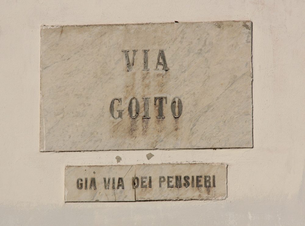 Street name sign on a building wall in Livorno, Italy
