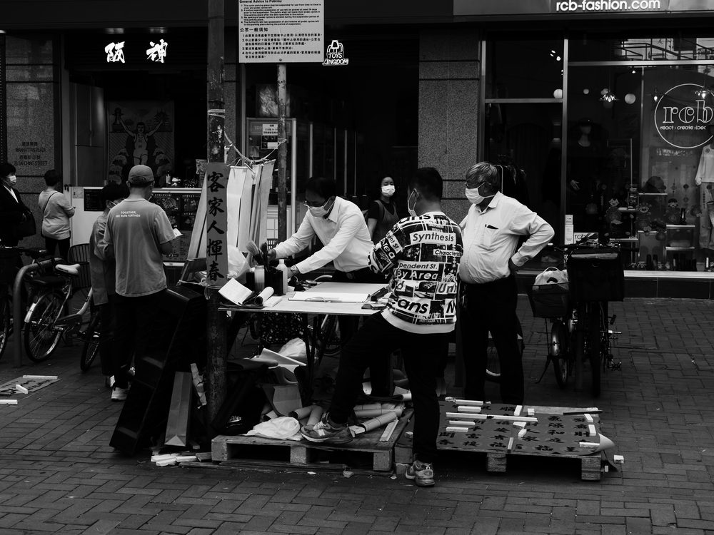 A man practising Chinese calligraphy, representing the study of Mandarin characters