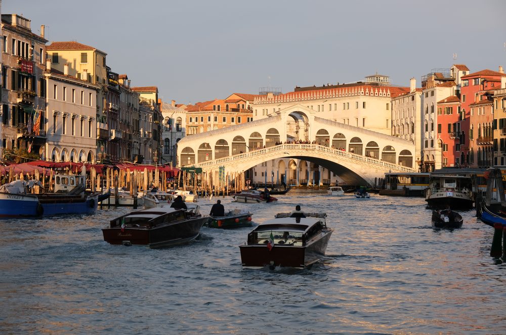 The Rialto Bridge in Venice, Italy, spanning a canal lined with historic buildings