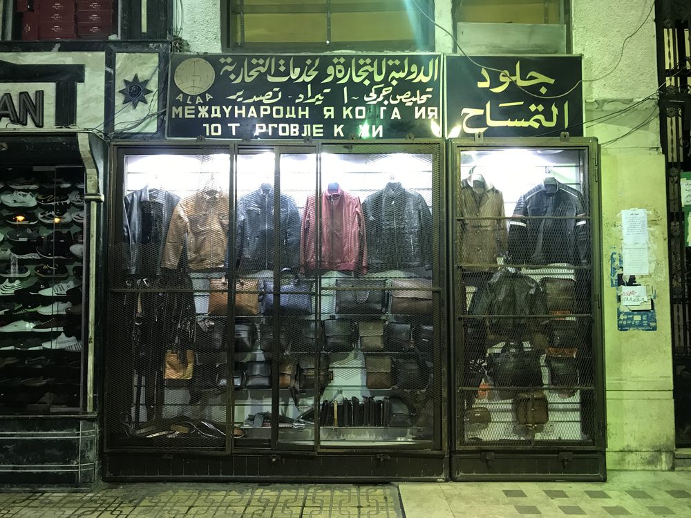 A shop front with Arabic signage on a street in Alexandria, Egypt