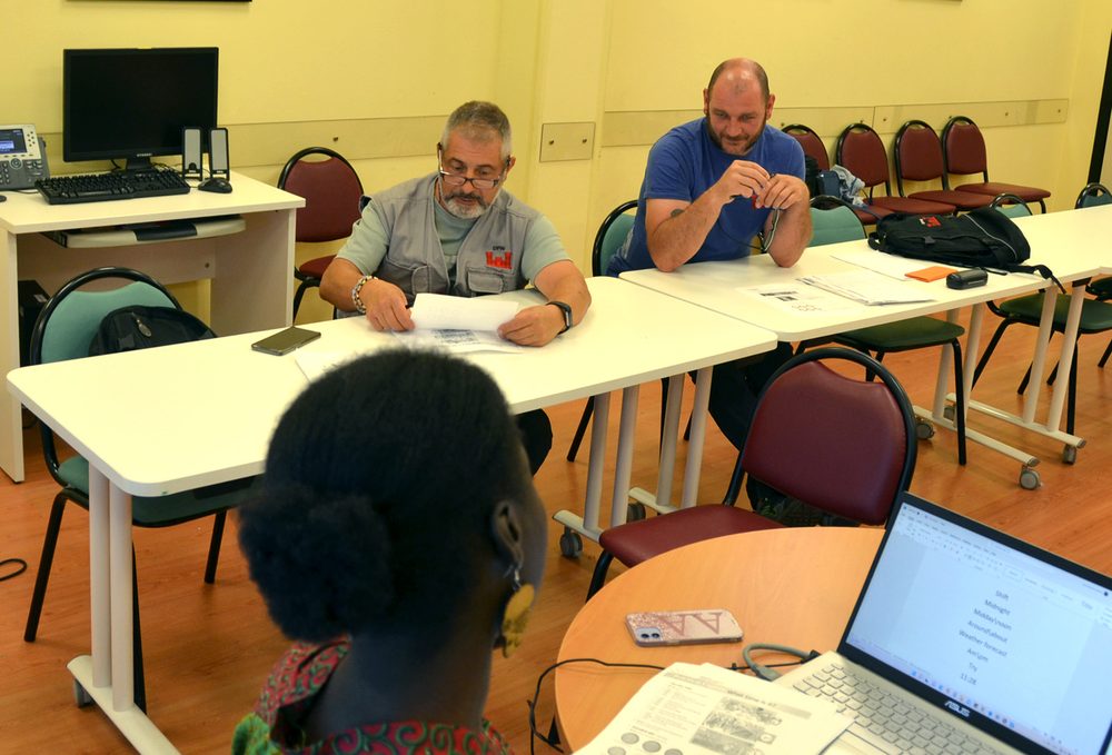 Adult learners studying English as a second language in a classroom