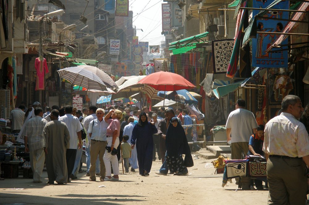 Muizz Street market in Islamic Cairo, Egypt, lined with shops and signage