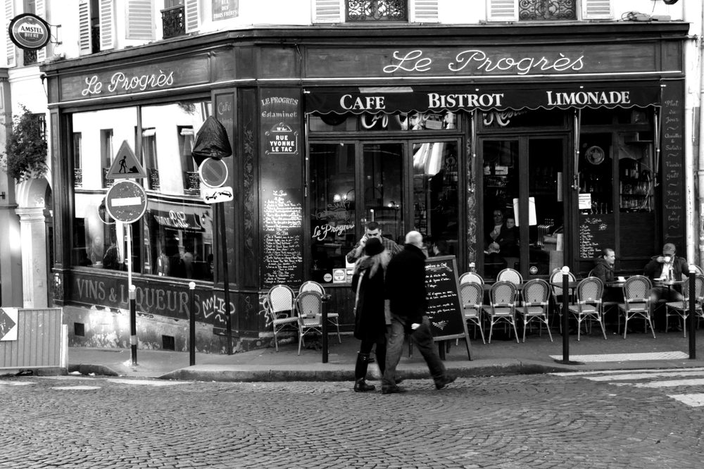A small French cafe and shopfront with a hand painted sign, a common setting for everyday French vocabulary