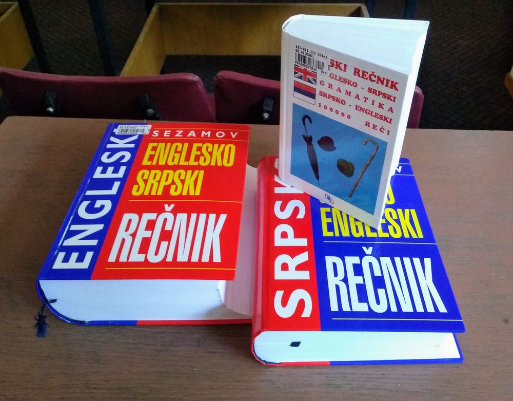 Two bilingual dictionaries side by side, representing vocabulary and word frequency in language learning