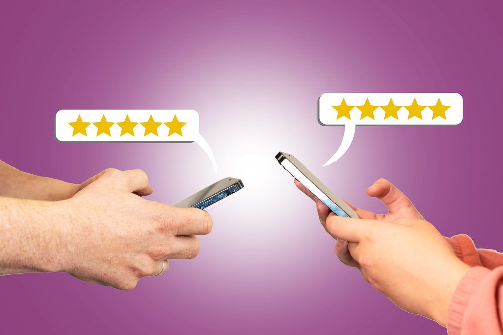 Customer giving a five-star rating as online feedback on a phone